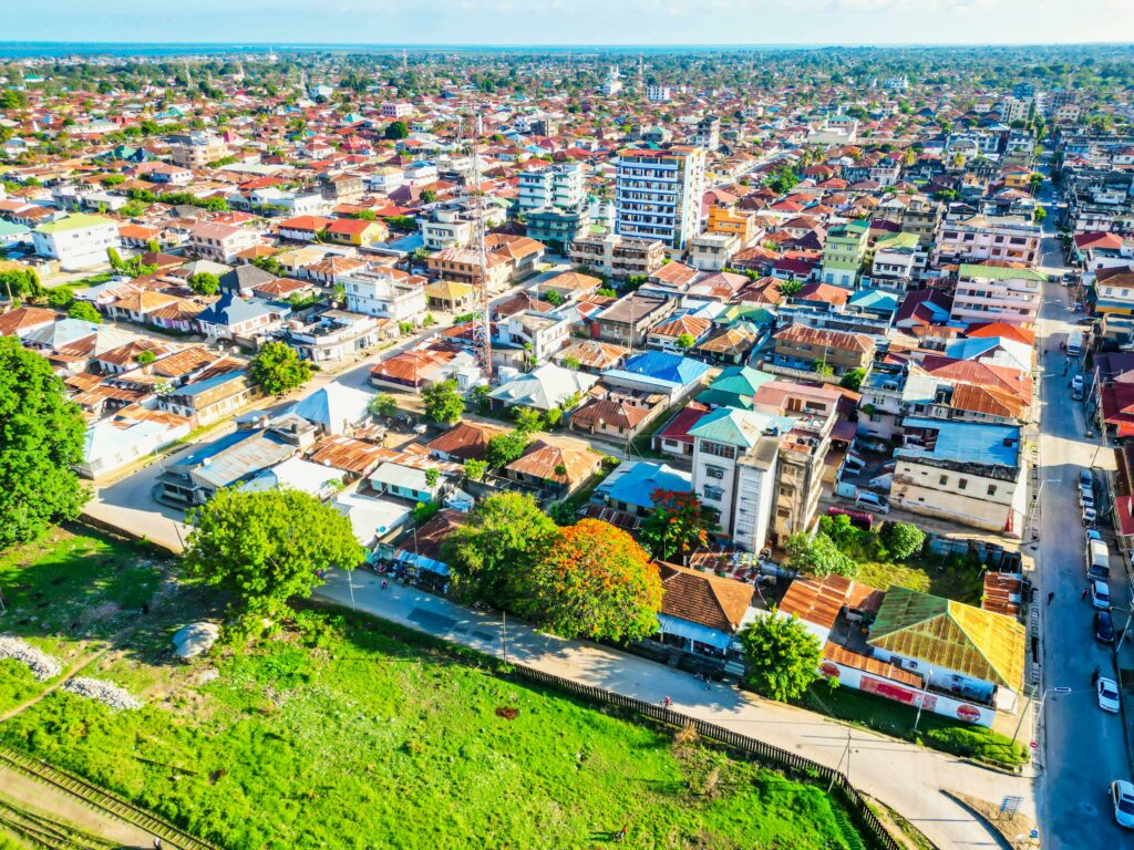 pexels-photo-15098115-15098115 Vibrant aerial view of a bustling cityscape with diverse rooftops and greenery.