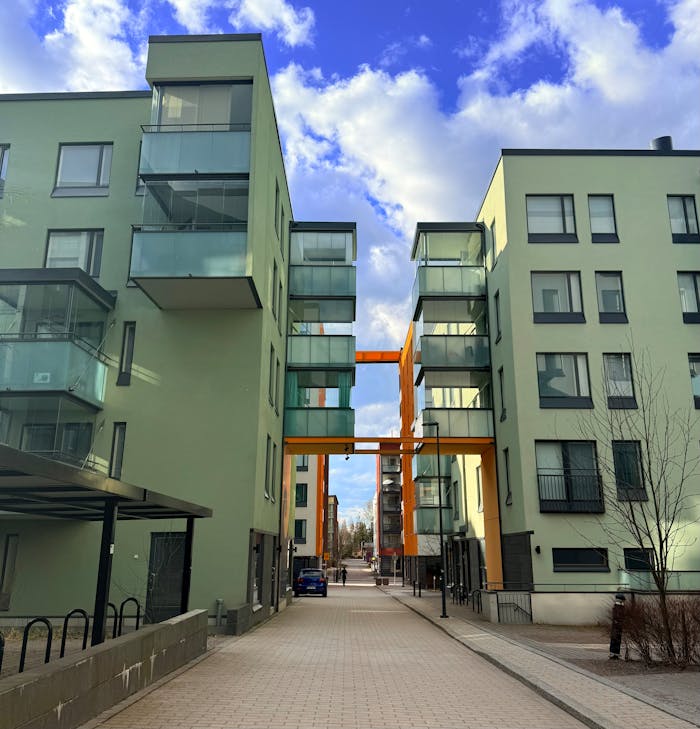 pexels-photo-37187308 Contemporary architecture of apartment buildings in Lahti, Finland under a vibrant blue sky.