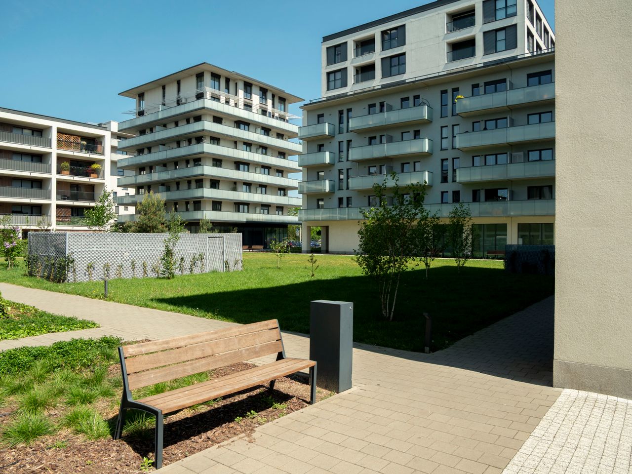 Contemporary apartment buildings with green spaces in Wrocław, Poland.